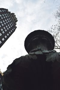 Low angle view of building against cloudy sky