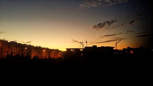 Silhouette cityscape against sky during sunset