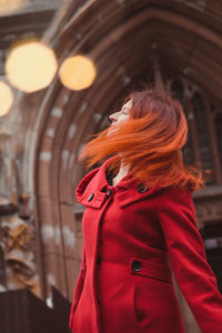 Close up happy redhead woman on city street portrait picture