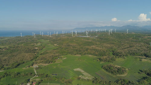 Aerial view of windmills for electric power production on the seashore. bangui windmills. solar farm