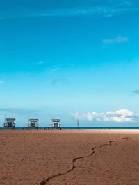 Scenic view of beach against blue sky