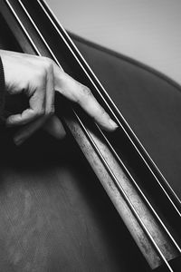 Cropped hand of person playing double bass