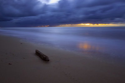 Scenic view of sea against cloudy sky