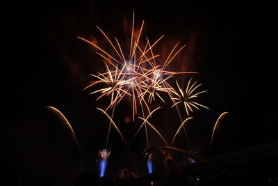 Low angle view of firework display at night