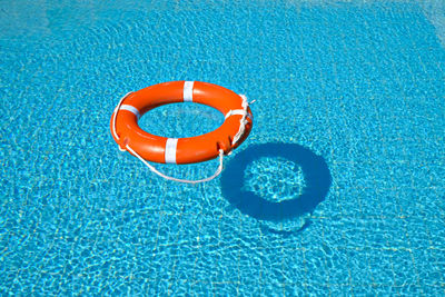 High angle view of life belt floating on swimming pool