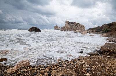 Scenic view of rocks in sea against sky