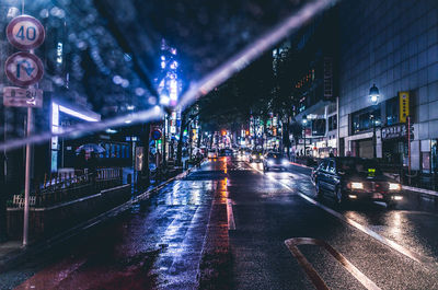 Illuminated road in city at night