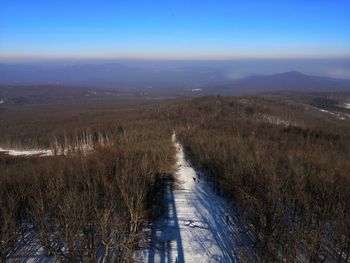 Scenic view of landscape against sky during winter