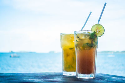 Drink in glasses against sea