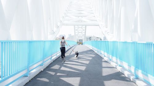 Rear view of people walking in tunnel