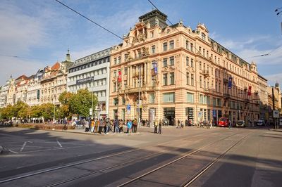 View of city street and buildings against sky