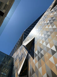 Low angle view of modern building against clear blue sky
