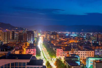 High angle view of illuminated buildings in city at night