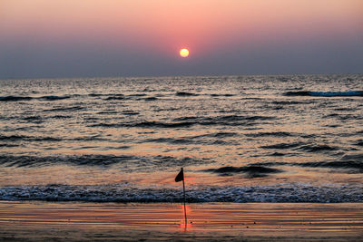 Scenic view of sea against clear sky during sunset