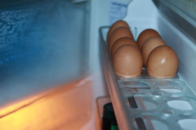 High angle view of eggs in glass container on table