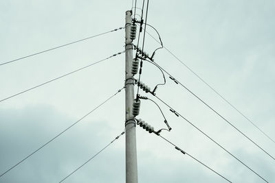 Low angle view of power lines against sky