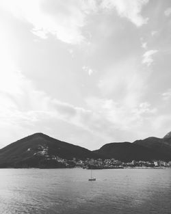 View of calm sea with mountain range in background