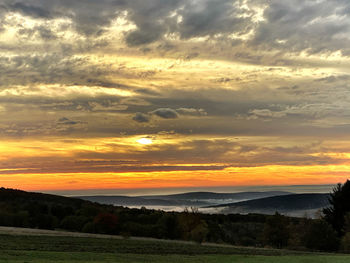 Scenic view of dramatic sky during sunset