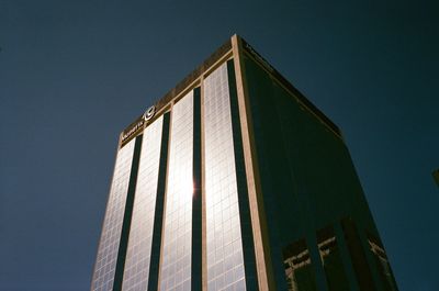 Low angle view of modern building against clear blue sky