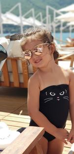 Girl wearing sunglasses and swimwear