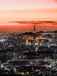 High angle view of illuminated buildings in city at night