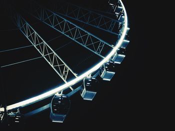 Low angle view of illuminated ferris wheel against sky