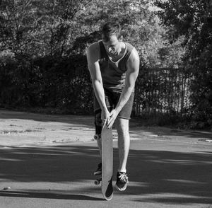 Full length of man skateboarding on road