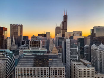 Modern buildings in city during sunset