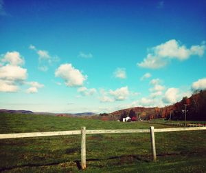 Scenic view of grassy field against cloudy sky