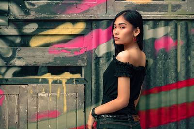 Portrait of beautiful young woman standing outdoors