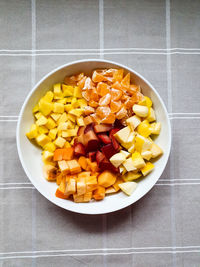 High angle view of chopped fruits in bowl on table