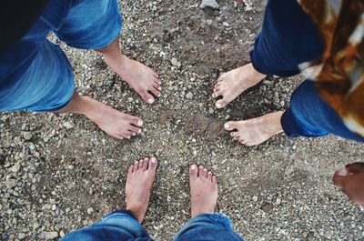 Low section of people standing at beach