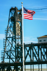 Low angle view of flag against blue sky