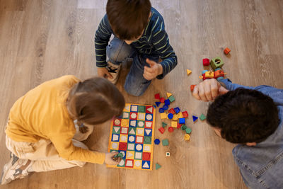 High angle view of boy playing with toy blocks