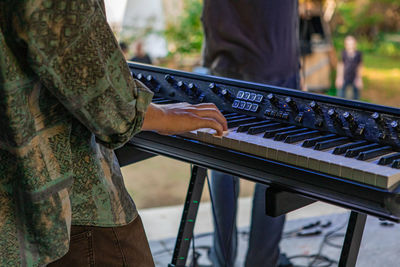 Midsection of man playing guitar