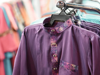 Close-up of clothes hanging on display at store