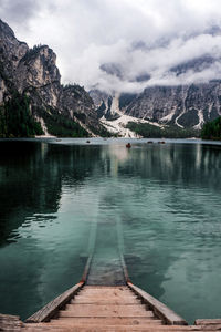 Staircase in lake against cloudy sky