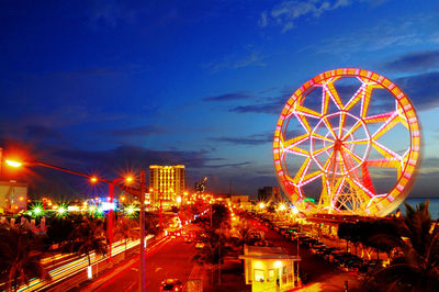 Ferris wheel against sky at dusk