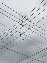 Low angle view of cables against sky