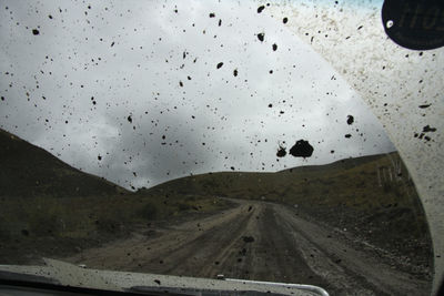 Scenic view of road seen through car windshield