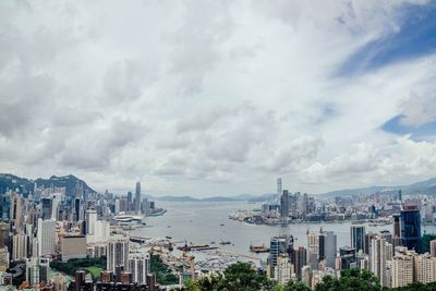 View of cityscape against cloudy sky