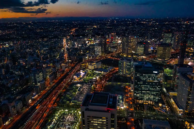 High angle view of illuminated city buildings at night