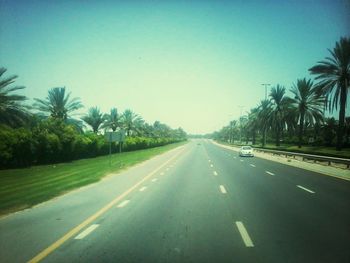 Empty road against blue sky