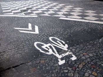 High angle view of arrow and bike symbol on road