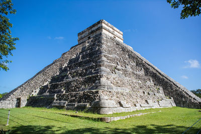 Low angle view of chichen itza against blue sky