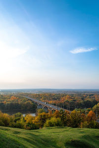 Arch bridge over river against sky