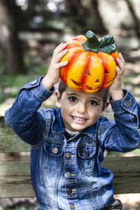 Portrait of smiling boy holding jack o lantern