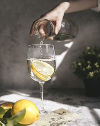 Close-up of hand holding drink in glass