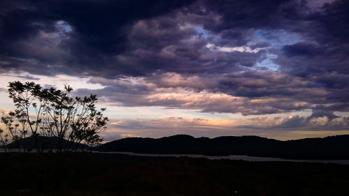 Scenic view of silhouette mountains against sky at sunset