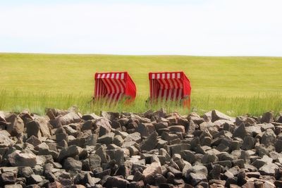 View of rocks on field against sky